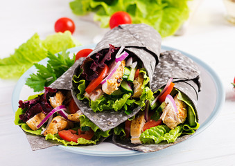 Tortilla with added ink cuttlefish wraps with chicken and vegetables on white background. Chicken...