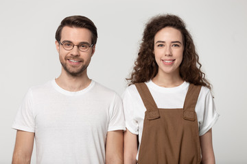 Fototapeta premium Attractive millennial girl and guy isolated on grey background