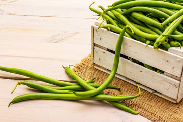 Phaseolus vulgaris, green common bean or kidney bean in wooden box