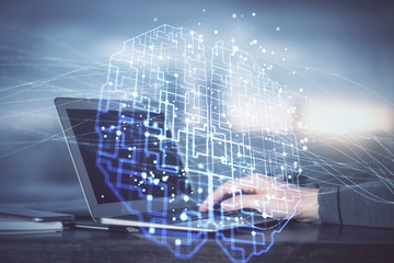 Man typing on keyboard background with brain hologram. Concept of big Data. Double exposure.