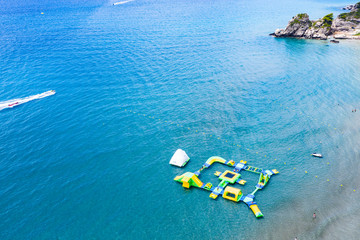 Aerial view of the ocean seashore. Floating boats at the seaside.