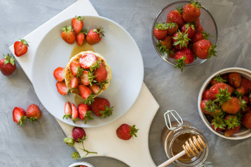 Cottage cheese pancakes syrniki with strawberries and honey. The concept of tasty healthy summer Breakfast. Top view,