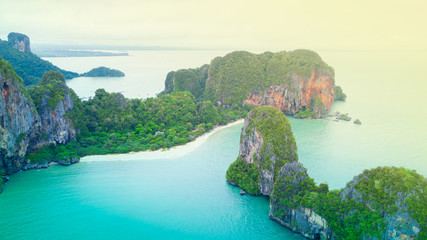 Aerial view of Phranag Beach, Railay Bay in Krabi Thailand with the spectacular mountain and white beach along the emerald water and island in morning