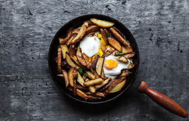 Fried potatoes and eggs in a pan close-up. horizontal