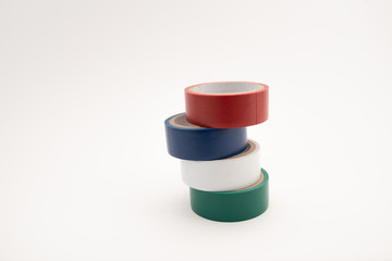 Rolls of insulation adhesive tape, multicolored isolating tape on white background