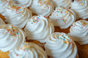 Gourmet Cupcakes with White Creamy and Sprinkles