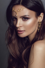 Beautiful girl in ethnic jewelry. Studio photoshoot with golden tiara - Image