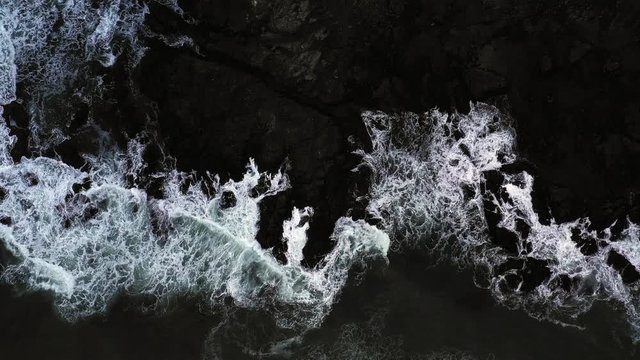 Top down view of giant ocean waves crashing and foaming