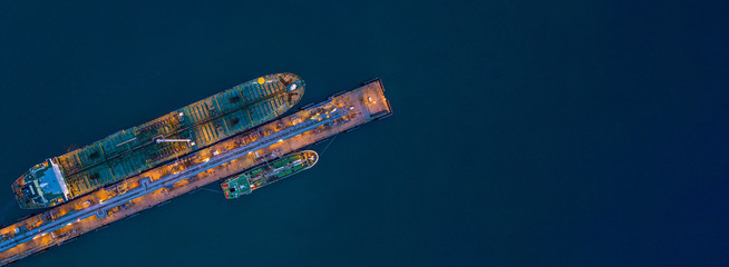 Aerial view tanker ship loading in port at night, Tanker ship logistic import export business and...