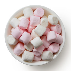 Pink and white mini marshmallows in white ceramic dish isolated on white from above.