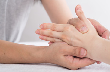 Fototapeta na wymiar Physiotherapist doing hand massage in medical office
