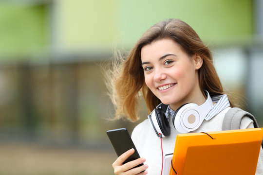 Happy Student Posing With Headphones And Phone