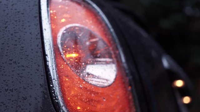 Closeup on a rear LED light of a car after the rain