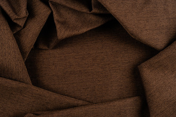 Texture of dark brown fabric close up.  