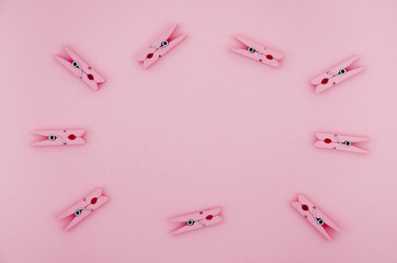 Flat-lay pink clothes pins frame