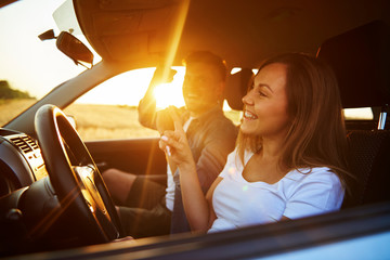 Cheerful couple having a fun during road trip