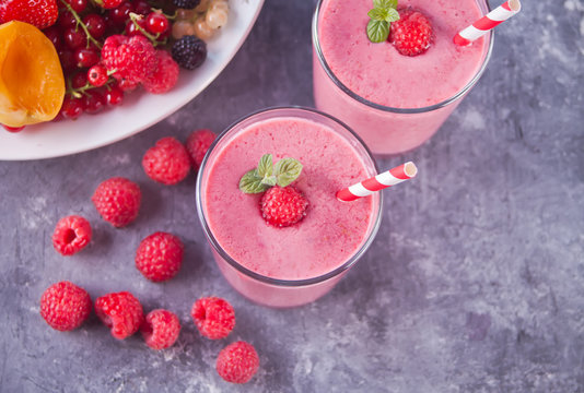Raspberry smothies and raspberry fruit on the cocreate background