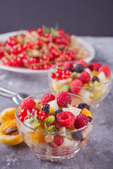 salad with fresh fruits and berries on a bowls on the concreate background