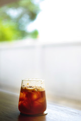 Sparkling ice coffee on wooden garden background 