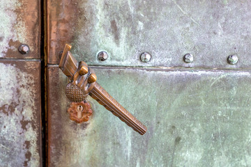 Bronze door handle on a portal entrance to a chapel