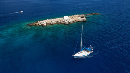 Obraz premium Aerial drone photo of small picturesque chapel of Agios Nikolaos built in small islet near picturesque main town of Hydra or Ydra island, Saronic gulf, Greece