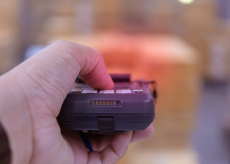 Scanning barcode to a box by handheld scanner.