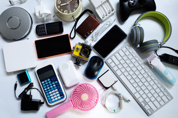 Many used modern Electronic gadgets for daily use on White floor, Reuse and Recycle concept, Top view.