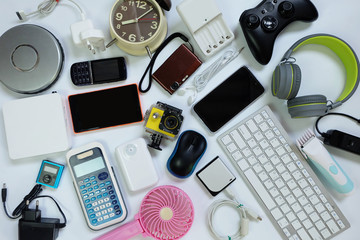 Many used modern Electronic gadgets for daily use on White floor, Reuse and Recycle concept, Top view.