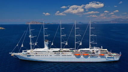 Aerial drone photo of classic cruise liner docked in deep blue Aegean sea