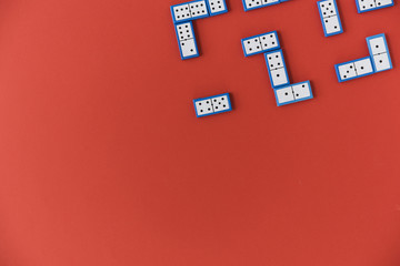 Top view domino pieces on red background