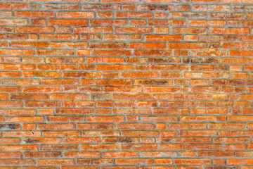 Grunge dirty orange and brown bricks wall as the abstract textured and background