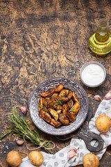 Baked young potatoes in a rustic style with sour cream