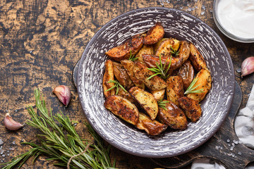 Baked young potatoes in a rustic style with sour cream
