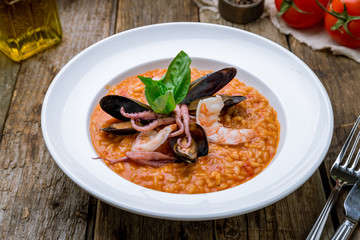 risotto with seafood on wooden table