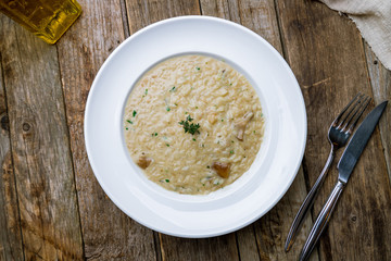 risotto with porcini mushrooms on wooden table