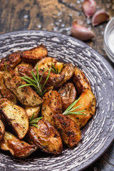 Baked young potatoes in a rustic style with sour cream