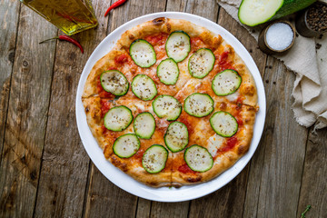 Fototapeta na wymiar Pizza with vegetables vegetarian on wooden table