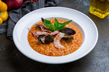 risotto with seafood on dark concrete background