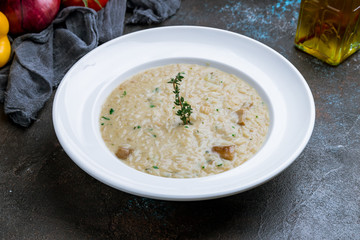 risotto with porcini mushrooms on dark concrete background