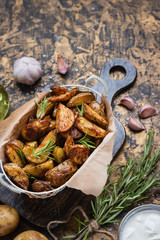 Baked young potatoes in a rustic style with sour cream