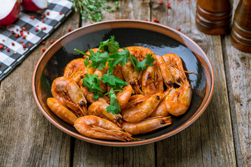 Tiger prawns on the grill on wooden background