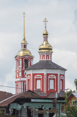 Fototapeta na wymiar Big red Christian church in the village - Suzdal, Russia
