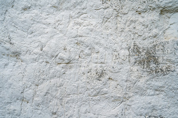 White natural chalk rock wall. Grunge gray and white background texture, close up