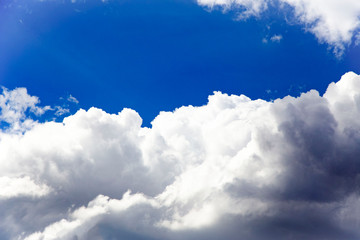 In the sky with white clouds.