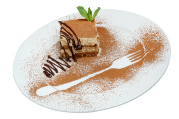 A piece of cake beautifully decorated and fork track cocoa on a plate on a white background