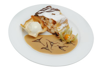 A piece of cake with ice cream beautifully decorated on a plate on a white background