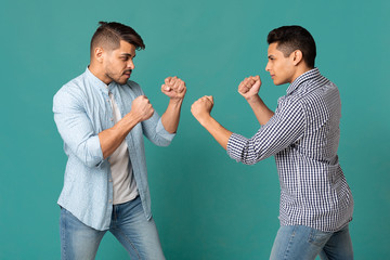 Two Arab Men Standing With Clenched Fists Ready To Fight