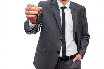 Male hand with car key close up isolated on white