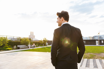 Back view of a young businessman wearing suit