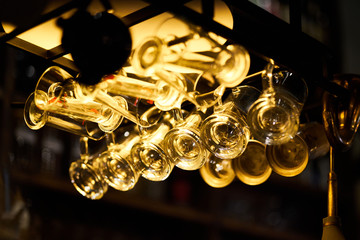 cups hanging in a bar